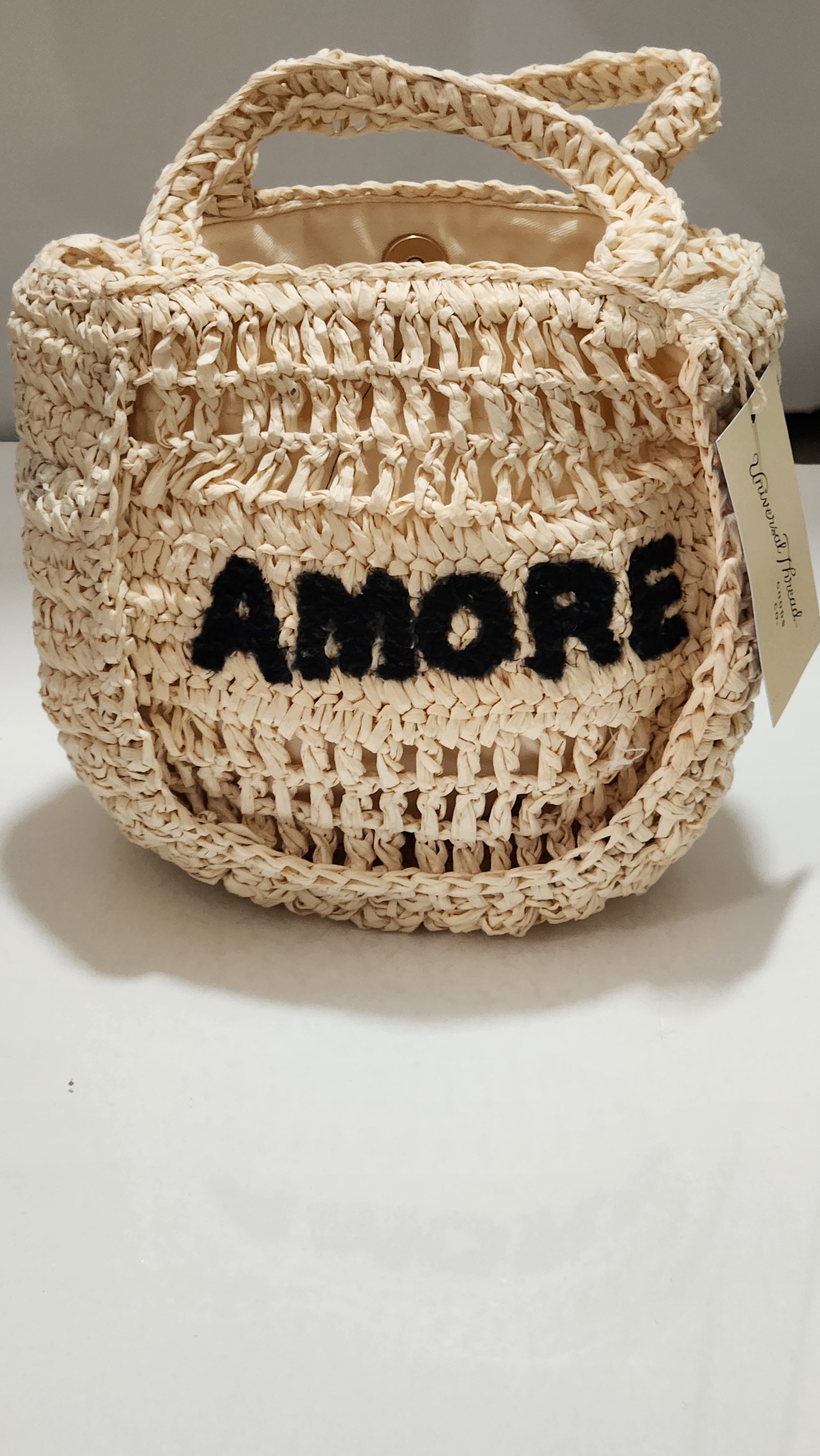 Woven bag with 'Amore' text on a white background
