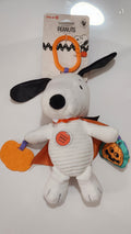 Plush toy resembling a dog with a Halloween-themed tag on a white background